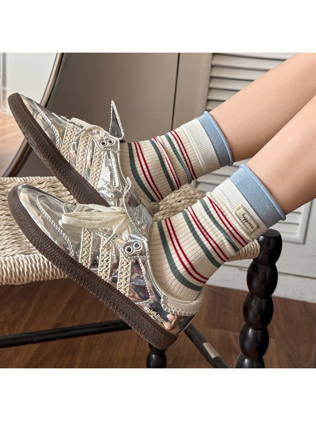 Ivory striped crew socks styled with metallic sneakers