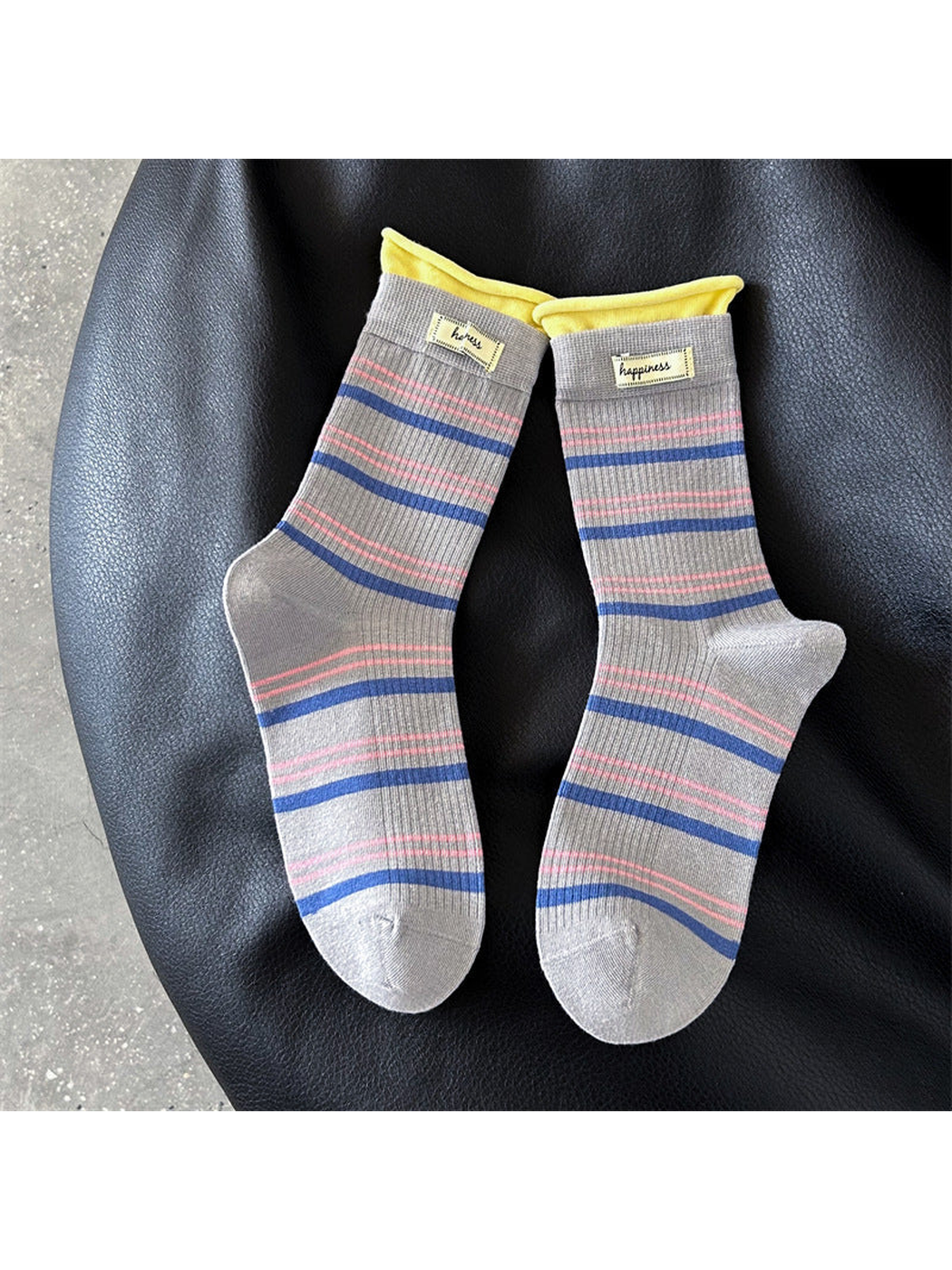 Gray crew socks with blue and pink stripes and yellow cuffs