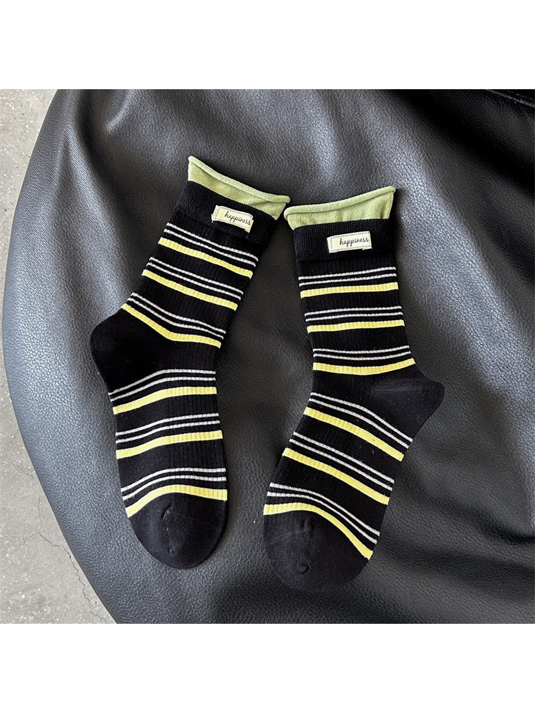 Black crew socks with yellow and white stripes and green cuffs