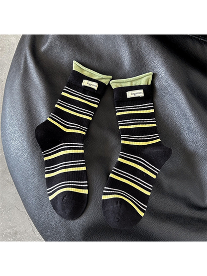 Black crew socks with yellow and white stripes and green cuffs