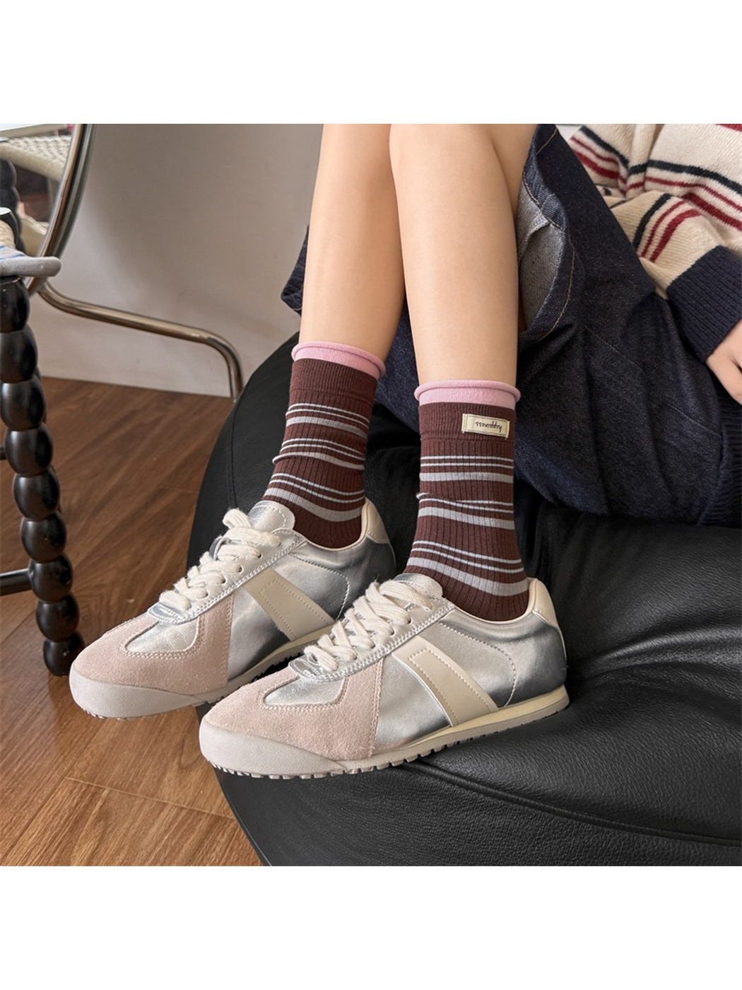 Brown striped crew socks worn with metallic sneakers