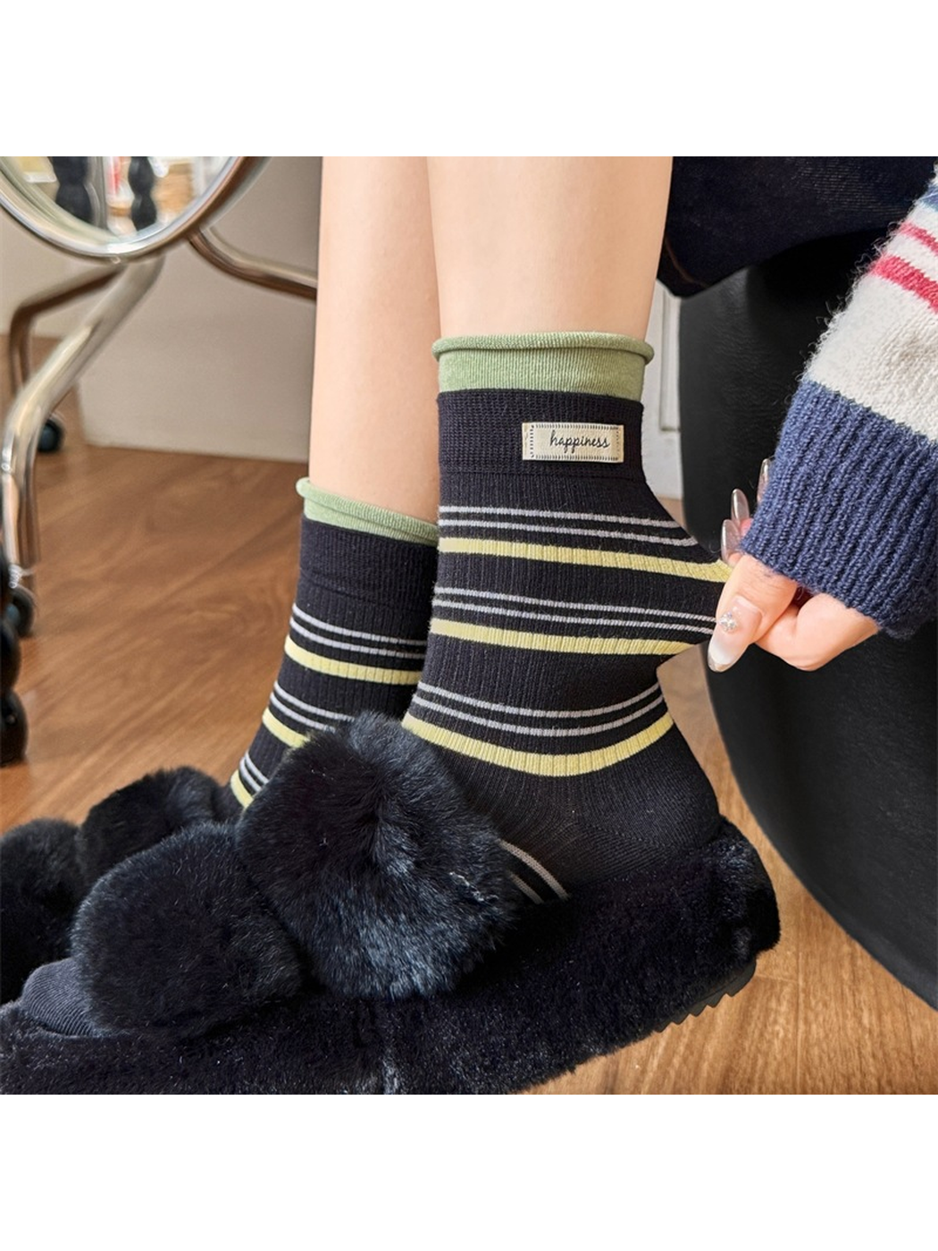 Close view of the striped black sock cuff being stretched
