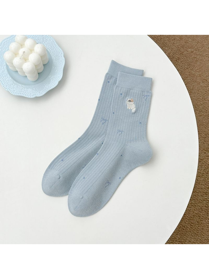 Light blue crew socks with embroidered animal, bow and dot motifs