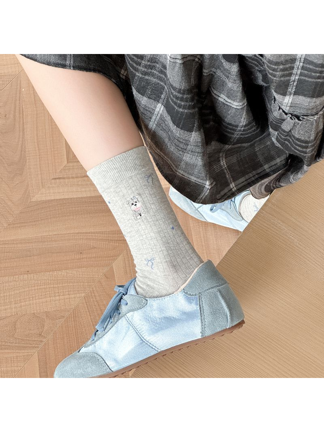 Light gray embroidered crew sock styled with a blue shoe