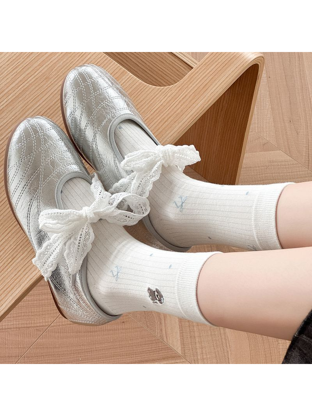 White embroidered crew socks styled with silver shoes