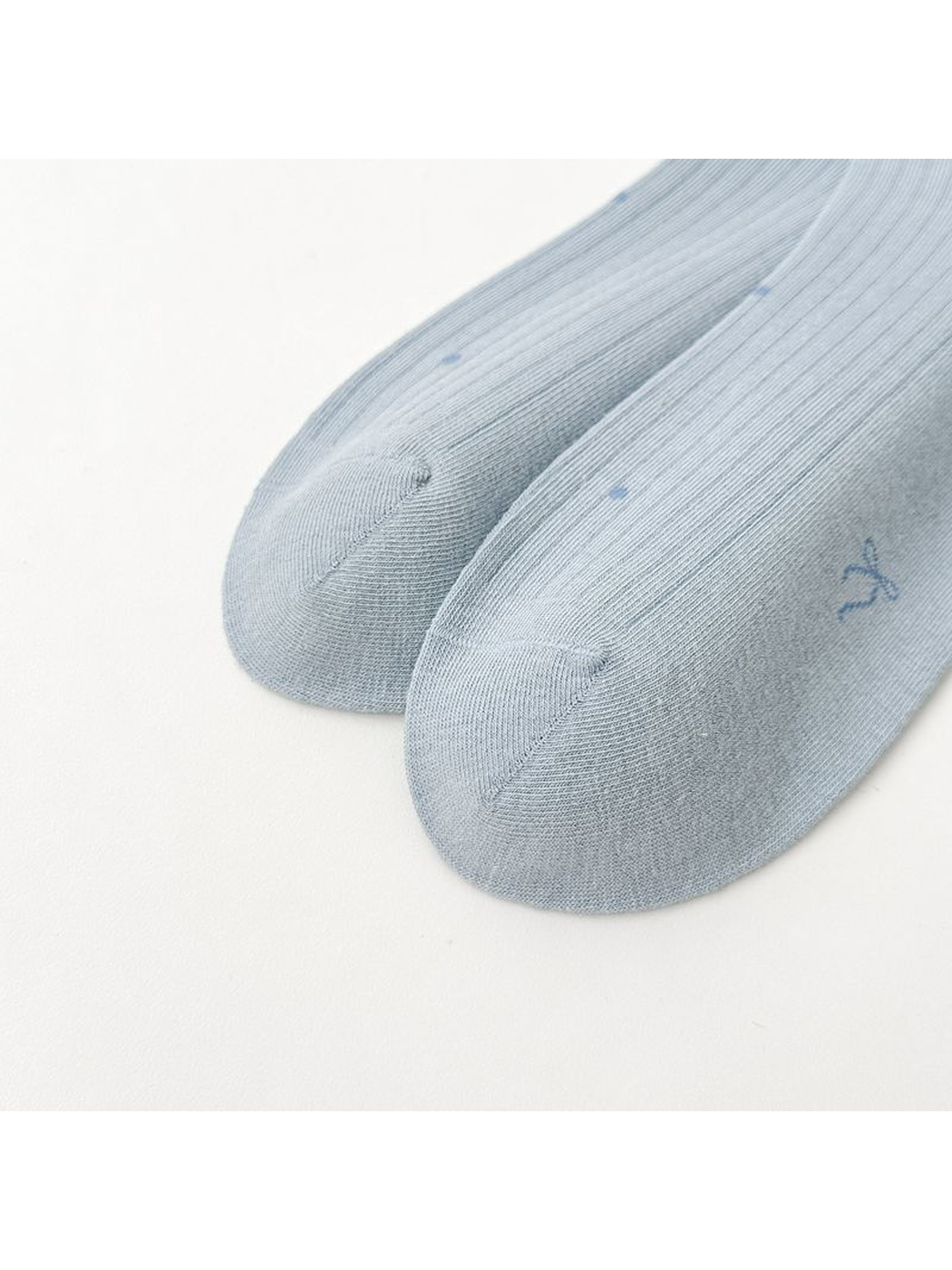 Close-up of the rounded toes and curved seams on light blue socks