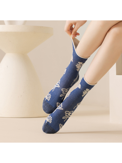Blue botanical crew socks with the cuff gently pulled outward