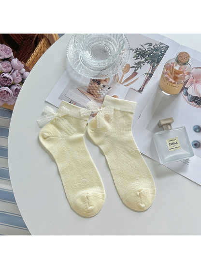 Pale yellow ankle socks with ivory lace bows