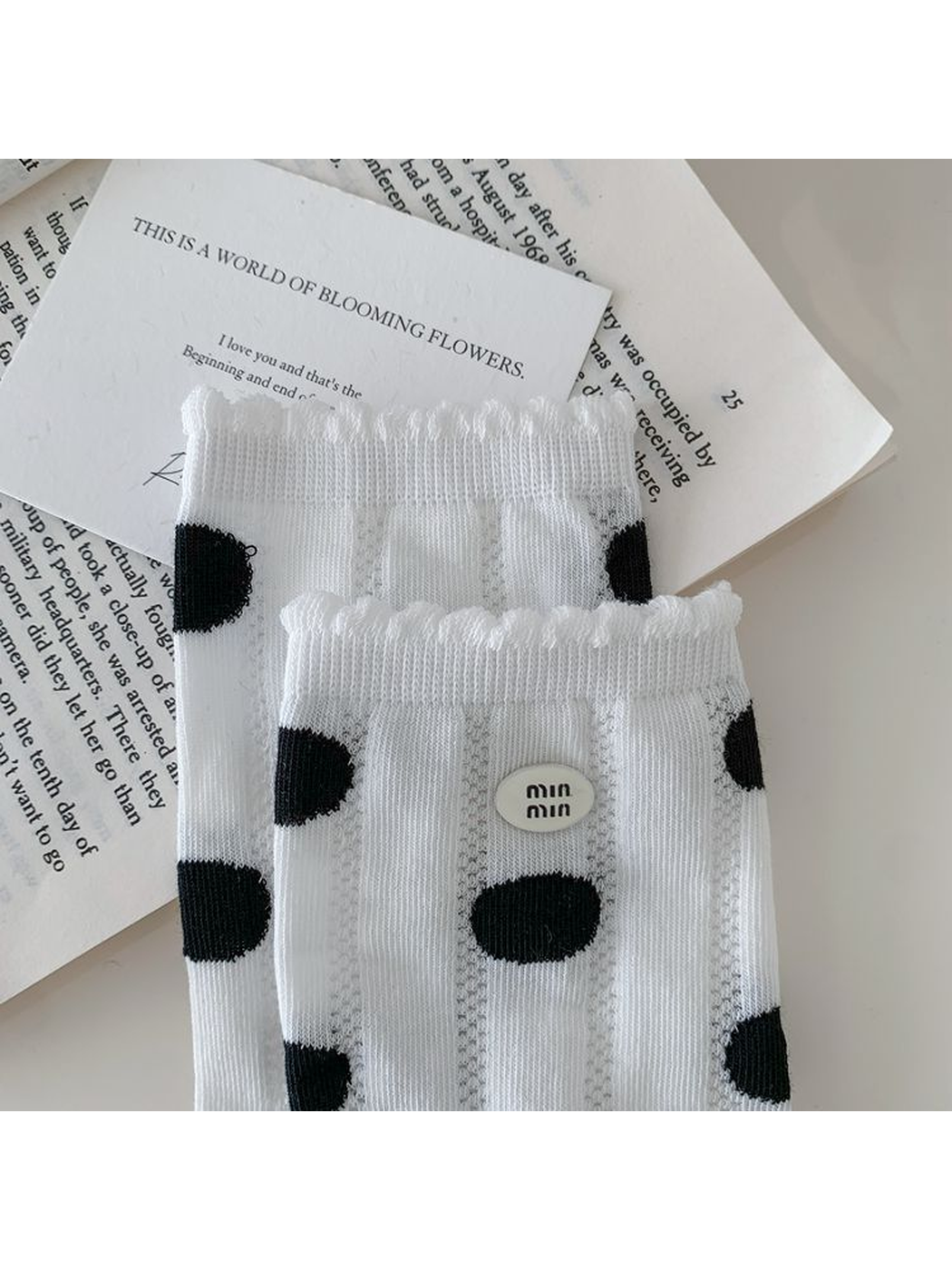 Close-up of the white sock's scalloped cuff and oval badge