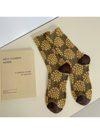 Brown crew socks with raised golden floral clusters