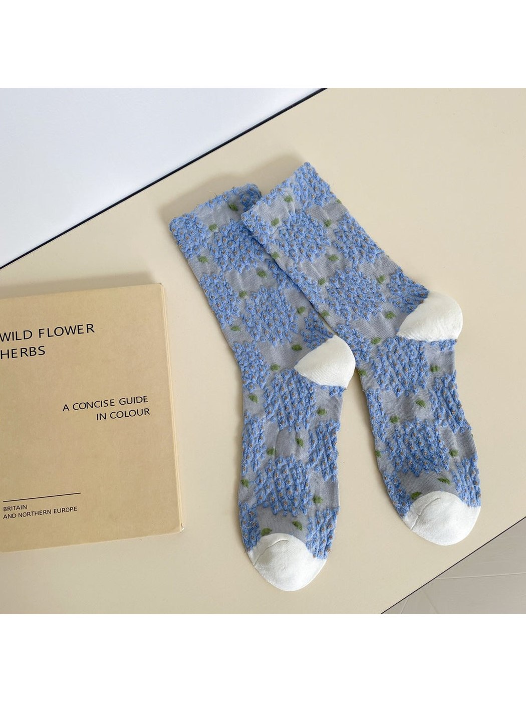 Light blue crew socks with raised blue floral clusters