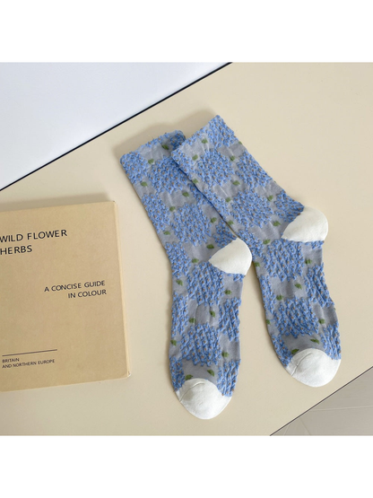 Light blue crew socks with raised blue floral clusters