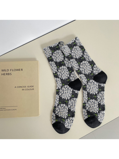 Black crew socks with raised white floral clusters