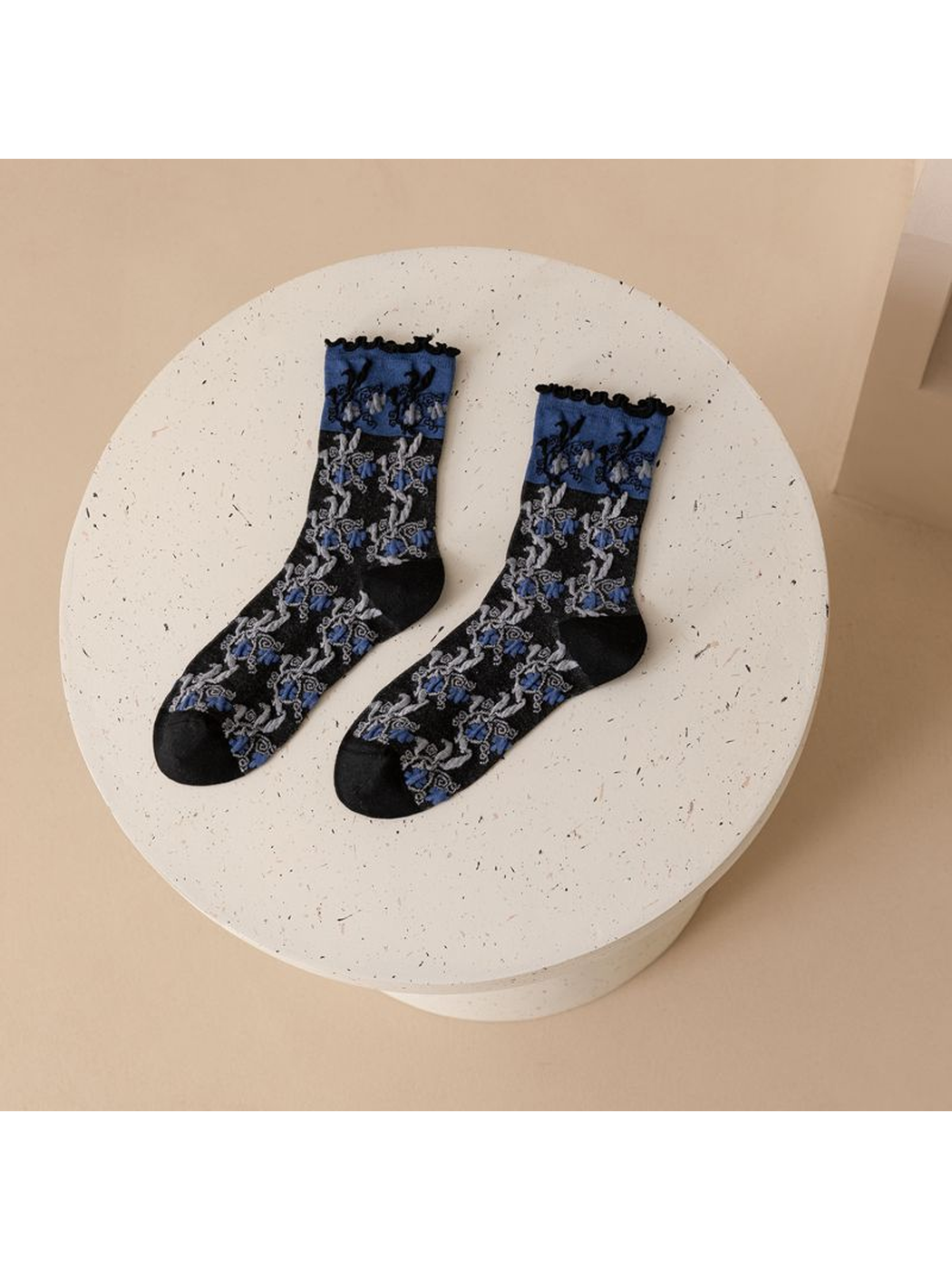 Black and cobalt-blue floral crew socks displayed as a pair