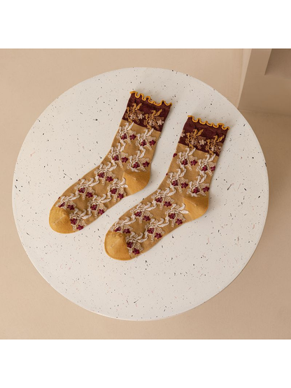 Mustard yellow and burgundy floral crew socks displayed as a pair