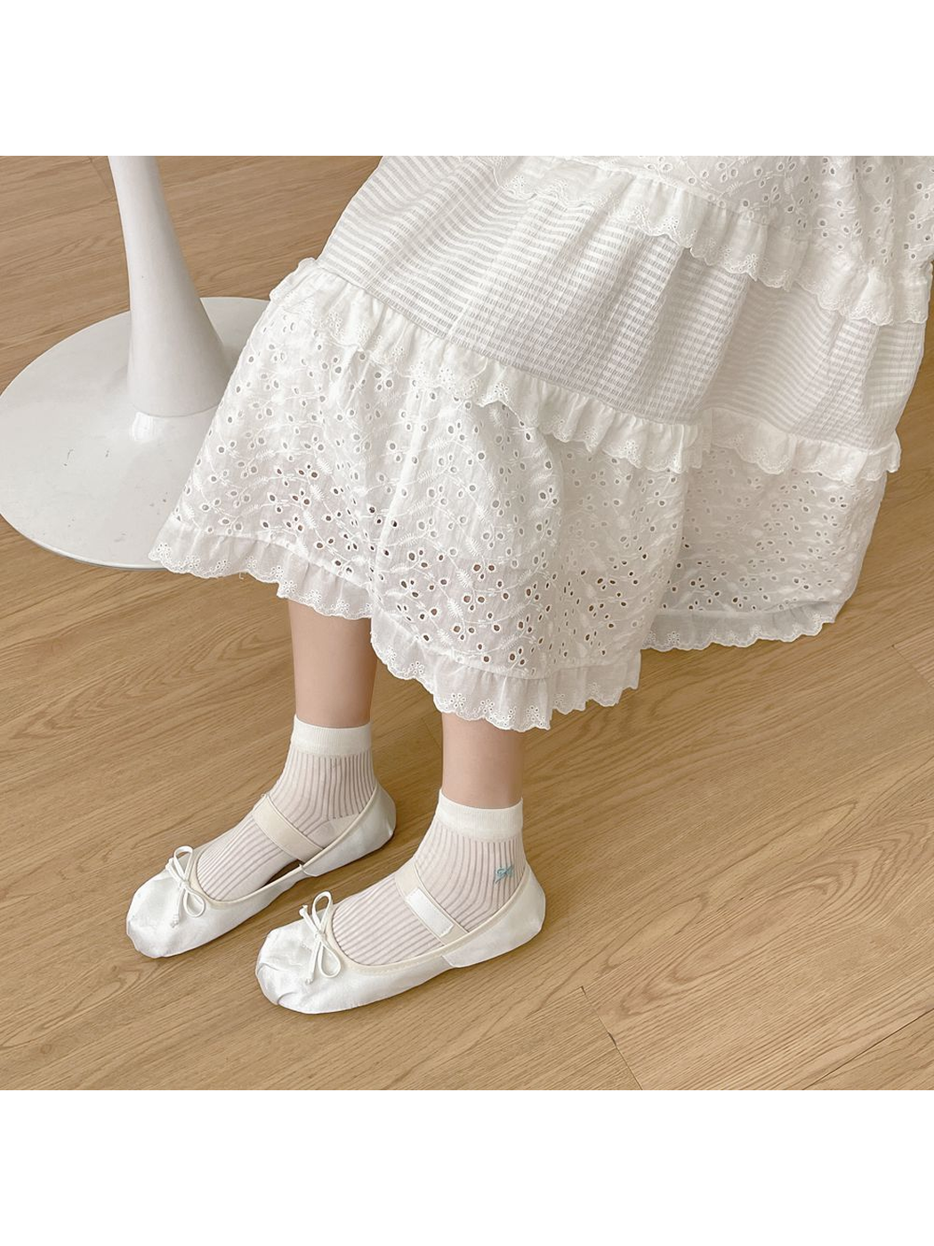 Ivory sheer ribbed ankle socks worn with white ballet flats