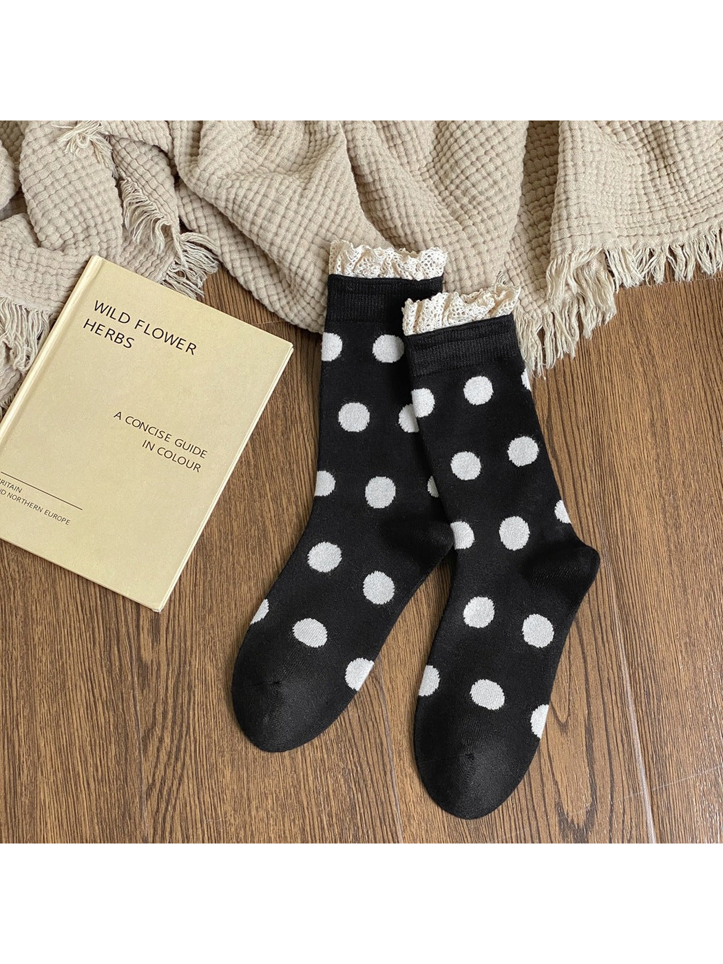 Black crew socks with white polka dots and cream lace-trimmed cuffs