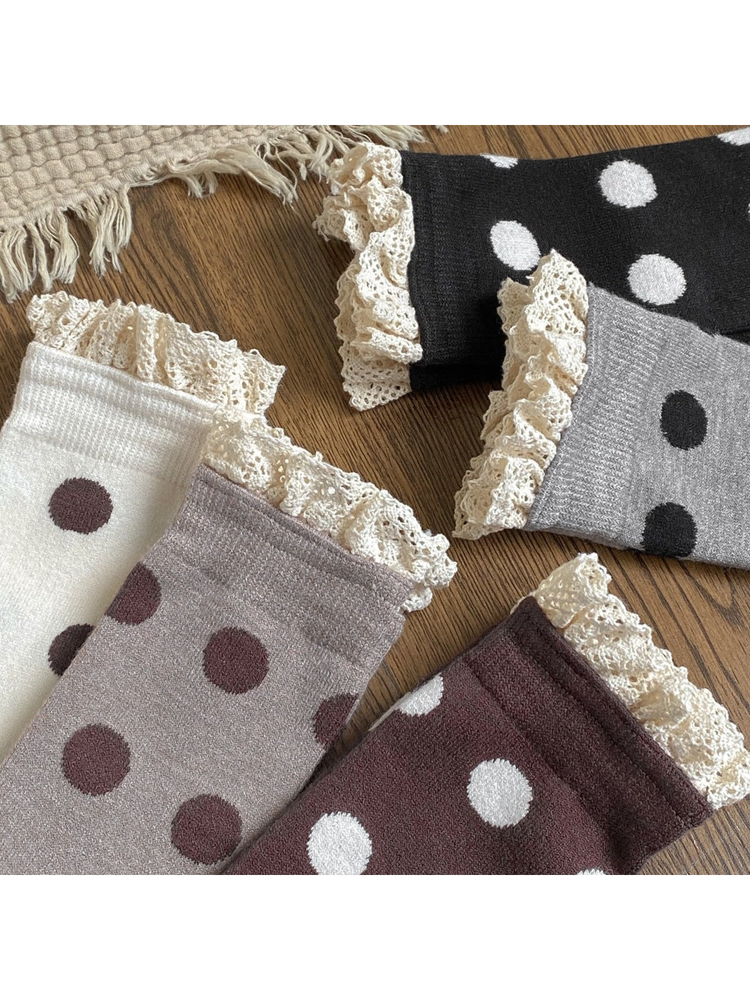 Close-up of polka dot socks with cream lace ruffles and ribbed cuffs