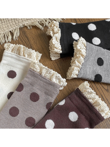 Close-up of polka dot socks with cream lace ruffles and ribbed cuffs
