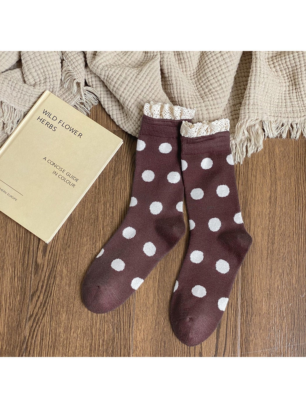 Dark brown crew socks with white polka dots and cream lace-trimmed cuffs