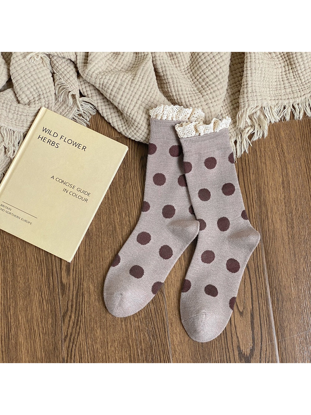 Light brown crew socks with dark brown polka dots and cream lace-trimmed cuffs