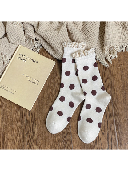White crew socks with dark brown polka dots and cream lace-trimmed cuffs