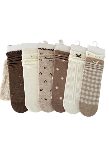 Six brown, beige and ivory crew sock styles displayed together