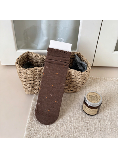 Dark brown crew sock with tiny scattered floral motifs and a ruffled cuff