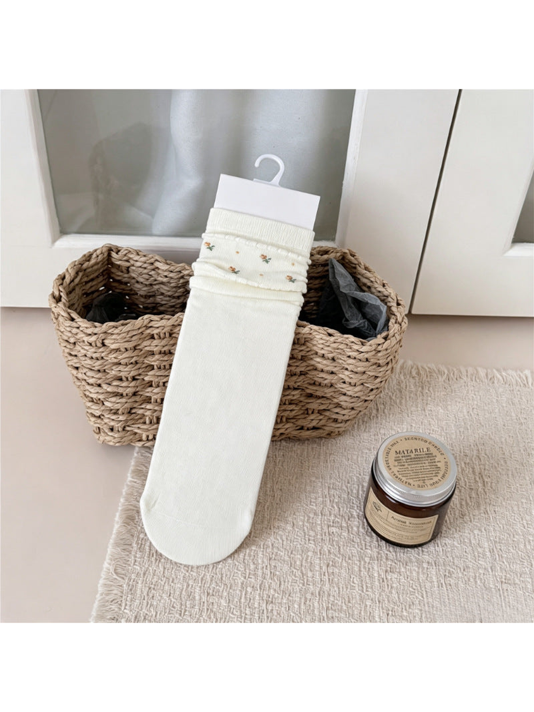 Ivory crew sock with tiny floral motifs around the folded cuff