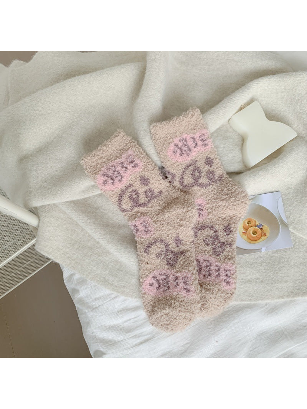 Beige fuzzy crew socks with pink blocks and purple loop motifs