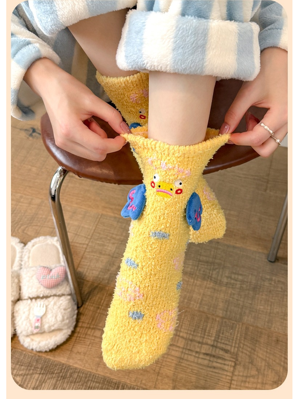 Yellow duck-motif crew sock being pulled on while seated