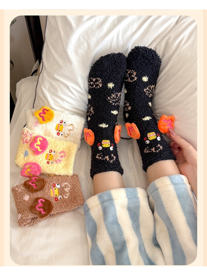 Black duck-motif crew socks worn on a bed beside cream and brown colorways