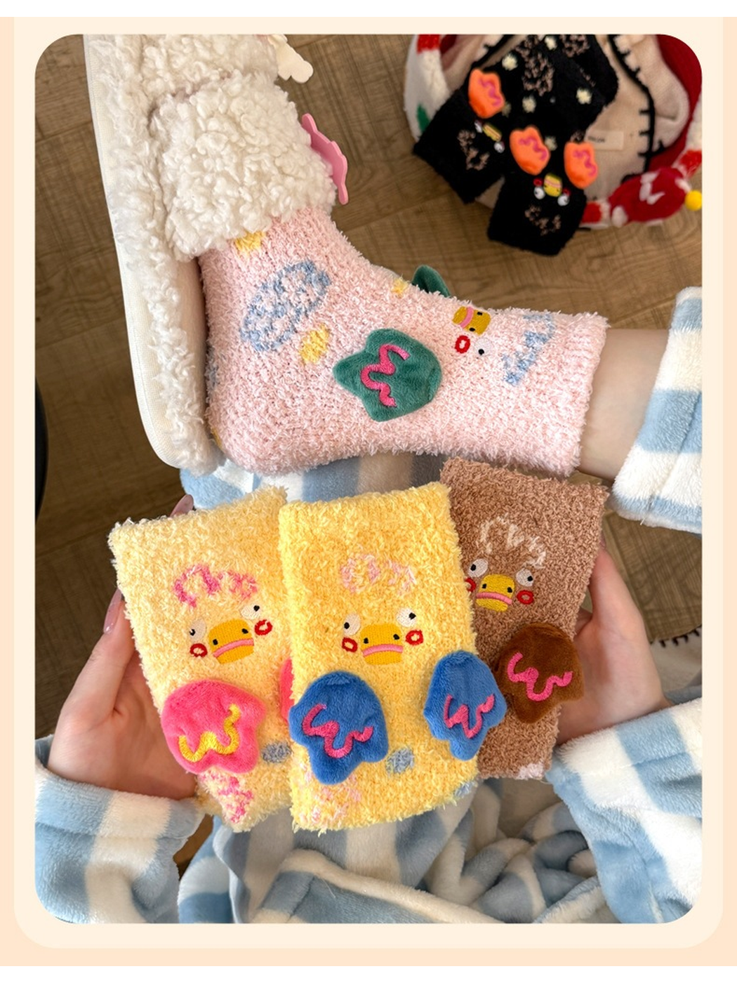Pink duck-motif crew sock worn above yellow and brown colorways held in both hands