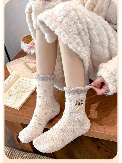 Cream dotted crew socks worn while seated, showing the full pair and contrasting cuffs