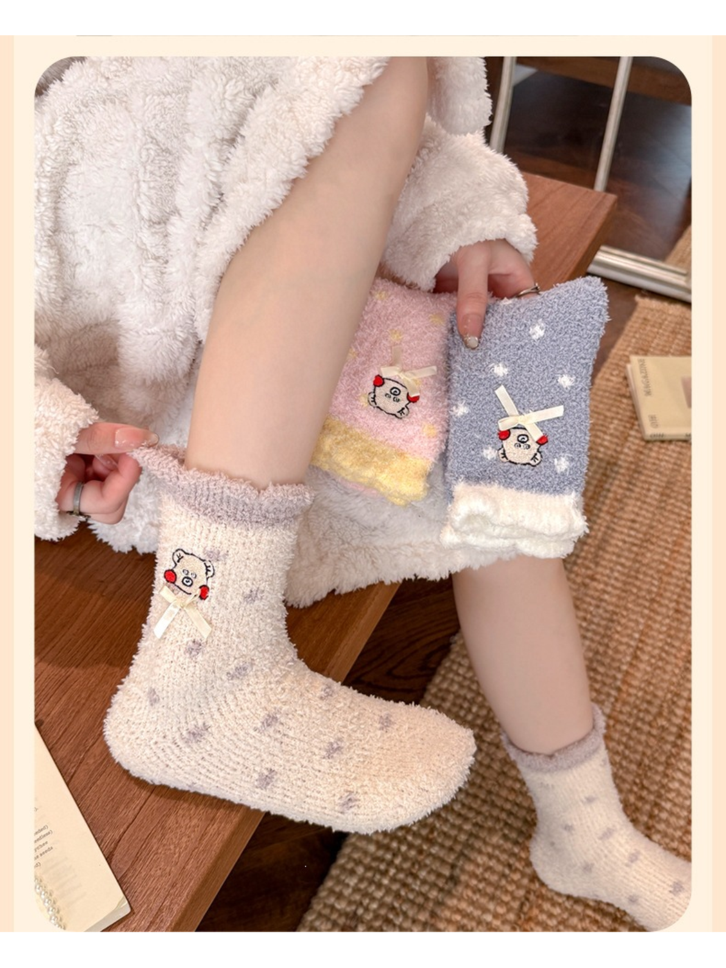 Cream dotted crew socks worn while seated beside folded pink and blue-gray styles