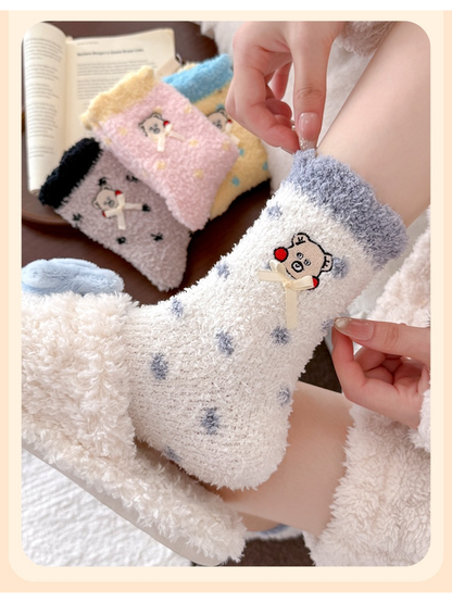 White dotted crew sock worn in a close view showing the blue-gray cuff and bear embroidery