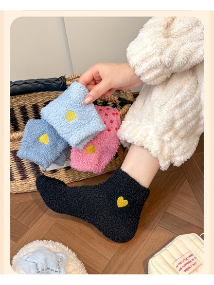 Black fuzzy ankle sock worn beside folded pink and blue color options