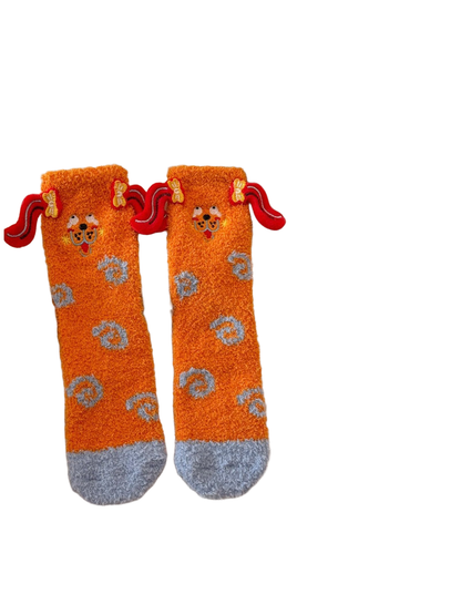 Orange fuzzy crew socks with gray toes and red ear appliqués