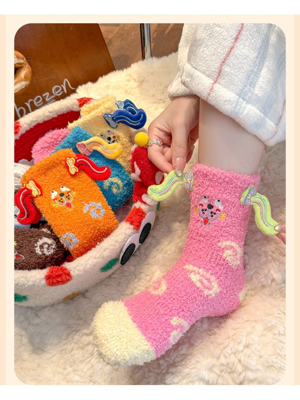 Rose pink fuzzy crew sock worn in profile beside a basket of colorful styles