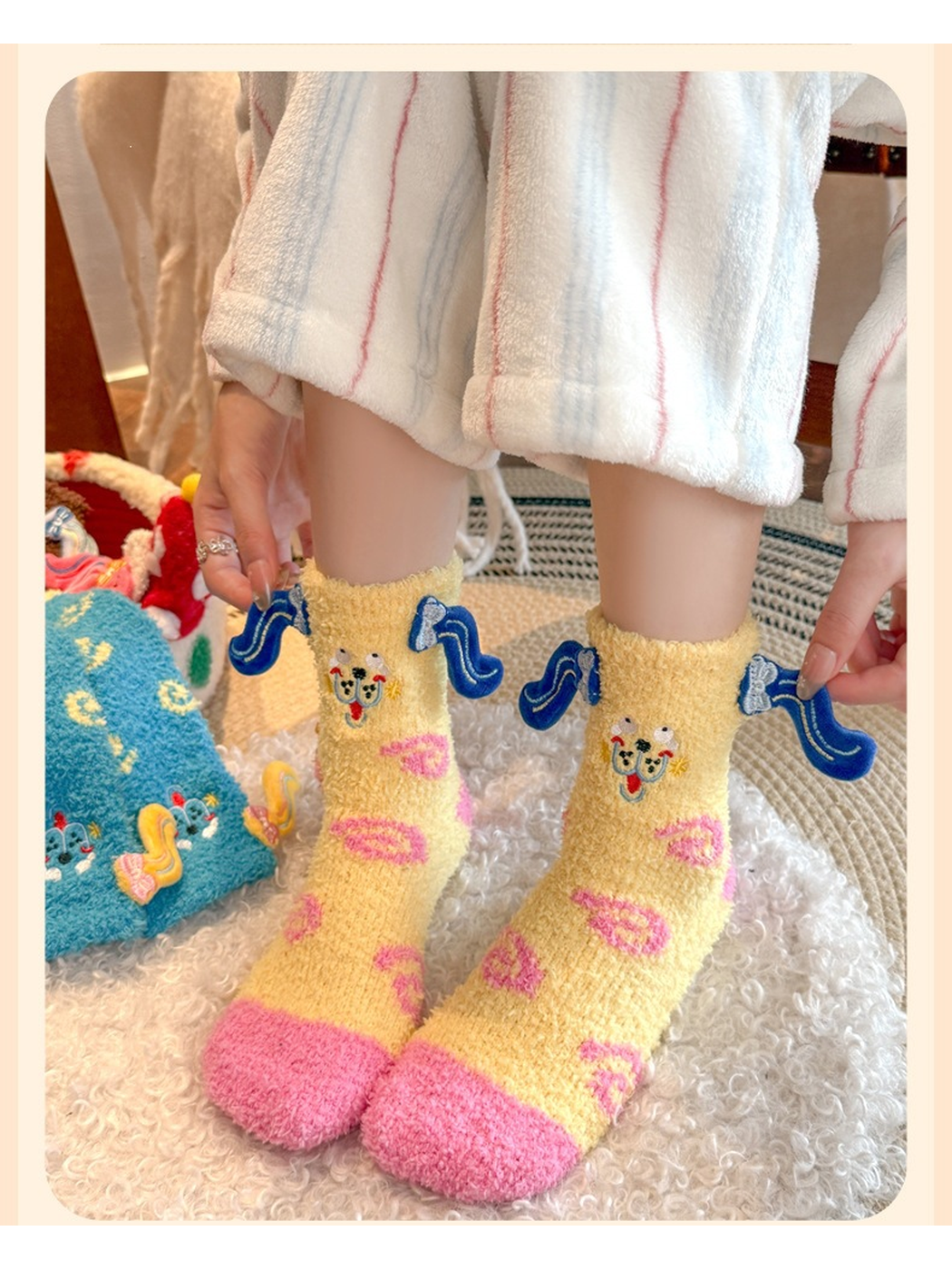 Pale yellow fuzzy crew socks worn with dark blue ear appliqués extended at the cuffs