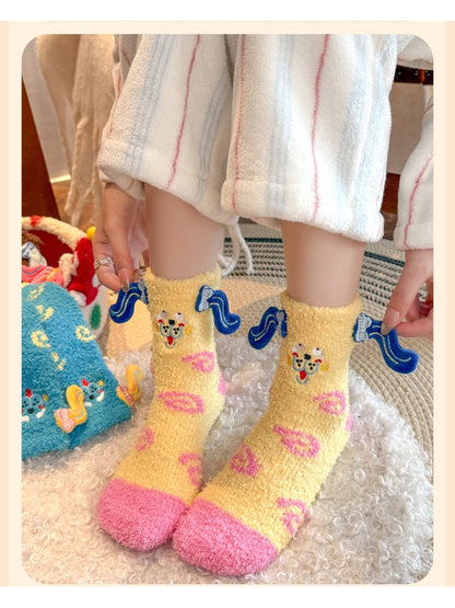 Pale yellow fuzzy crew socks worn with dark blue ear appliqués extended at the cuffs