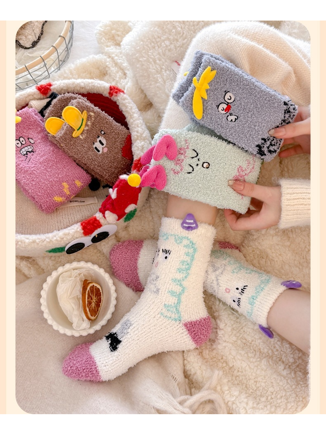 White character socks worn beside folded pink, mint, gray and brown designs