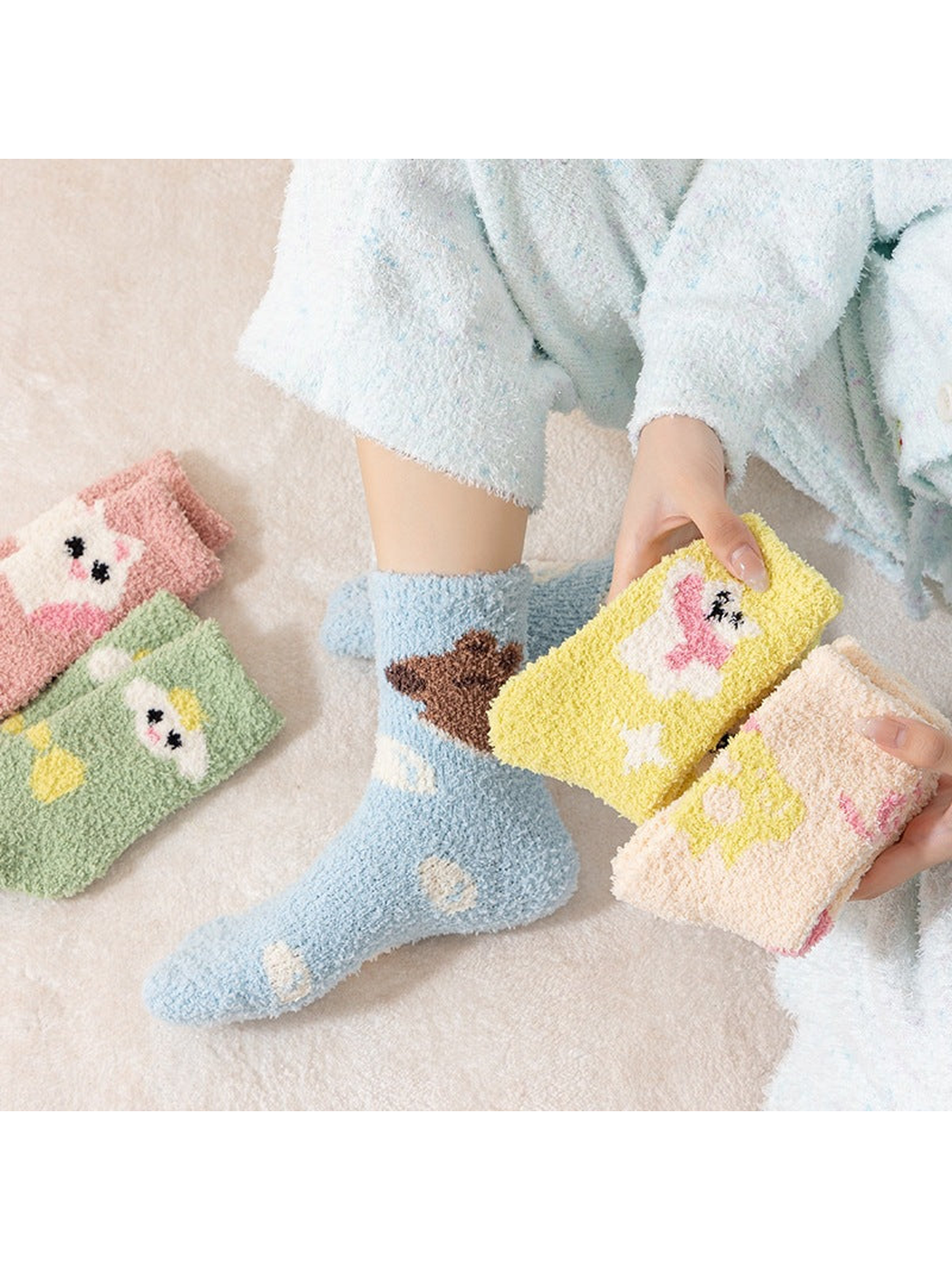 Assorted fuzzy crew socks displayed with one light blue pair worn