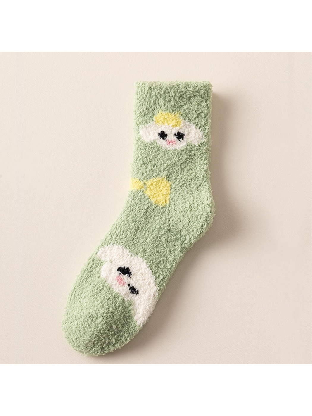 Green fuzzy crew sock with cartoon face motifs