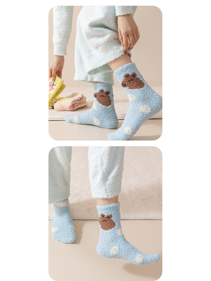 Light blue bear-motif fuzzy crew socks worn in two side views
