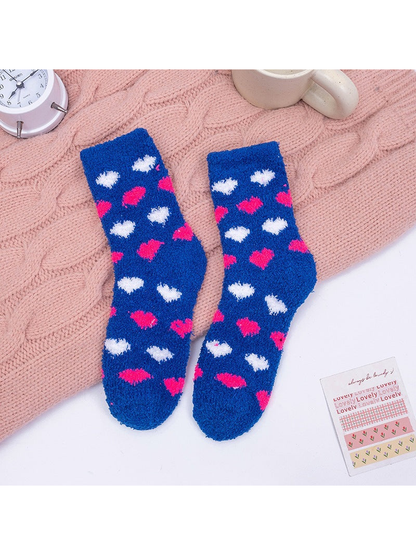 Blue fuzzy crew socks with pink and white heart motifs
