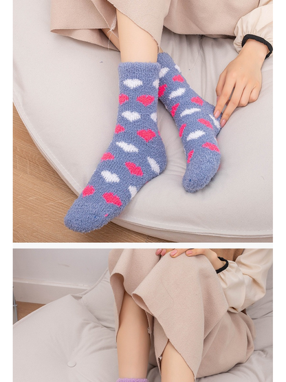 Gray-blue heart-pattern fuzzy crew socks worn while seated indoors