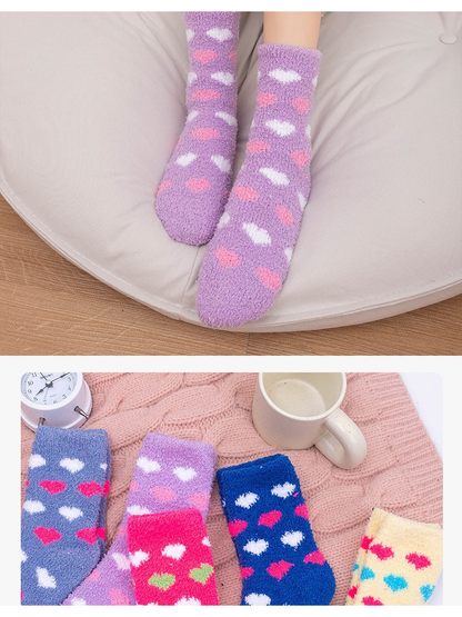 Light purple heart-pattern socks worn indoors with an assortment view below