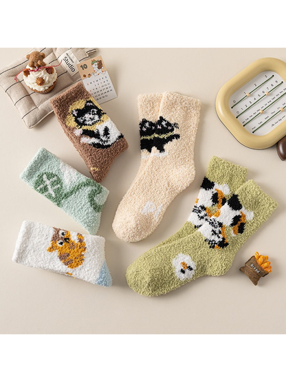 Five fuzzy crew sock designs arranged in a flat lay