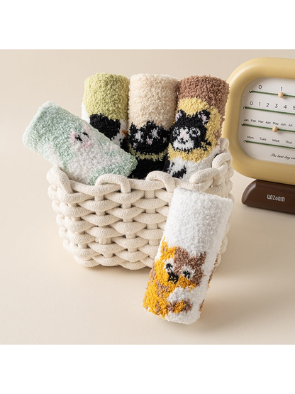 Assorted fuzzy animal-pattern crew socks arranged in a woven basket